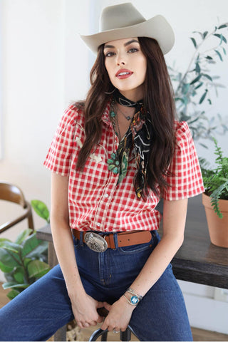 woman in hat with red & white gingham check western shirt on