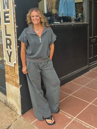 Charcoal color sweatpants with drawstring and wide leg shown with matching top on blonde woman